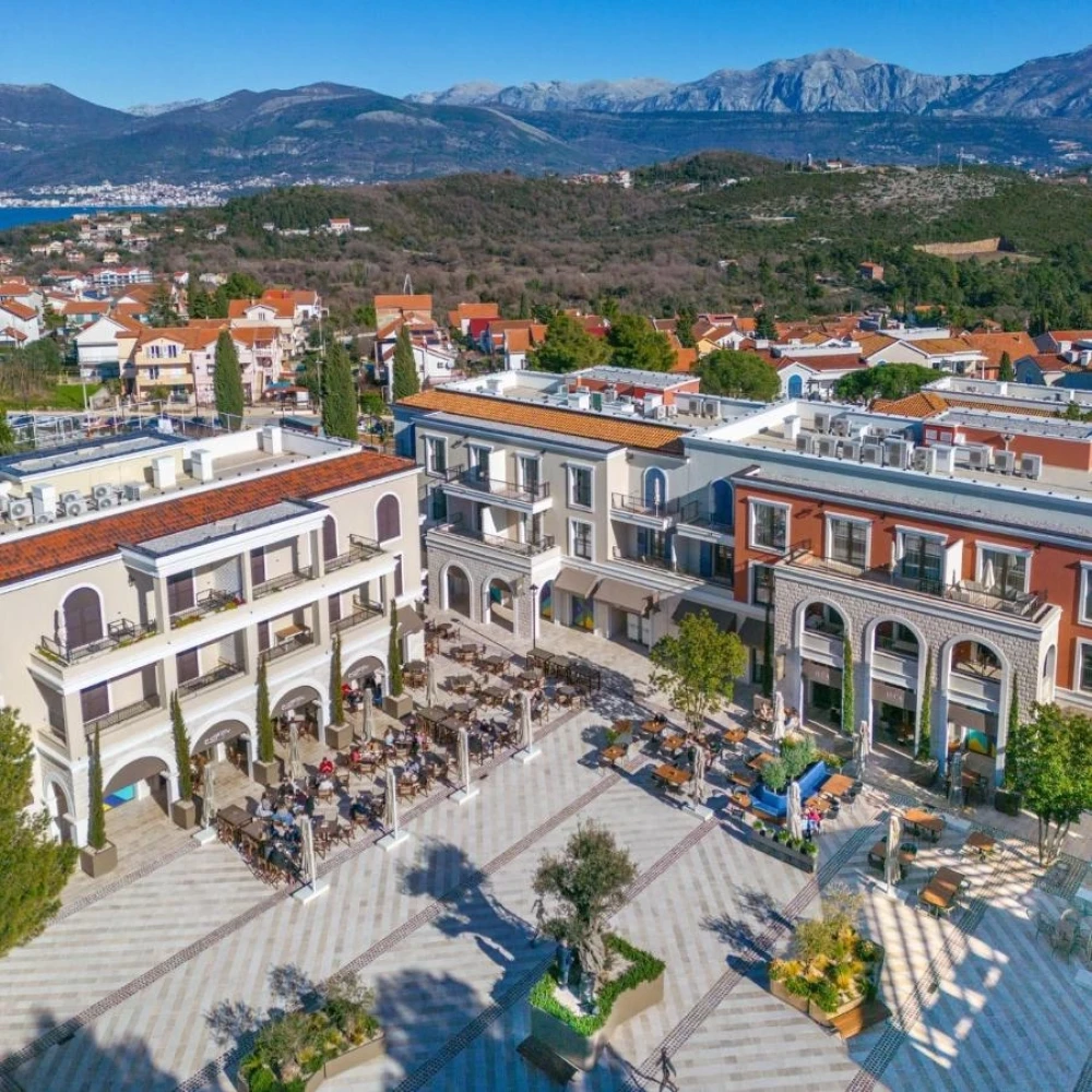 Vibrant Central Area of Lustica Bay with Shops and Dining Options